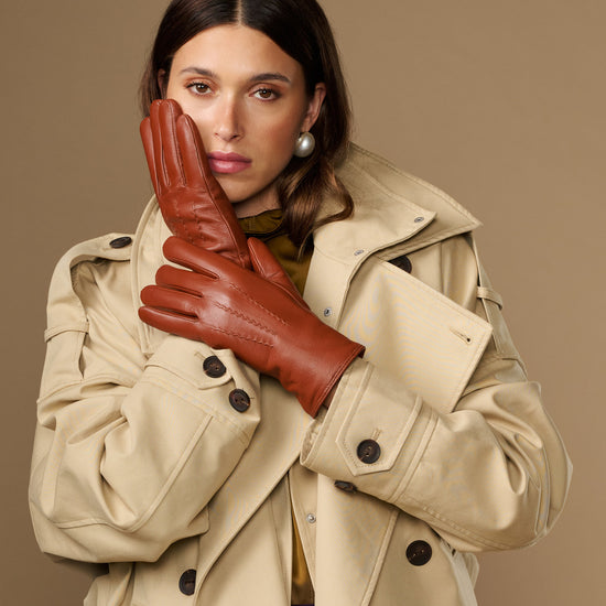 Cognac brown goatskin leather gloves with clean seams and five-finger design