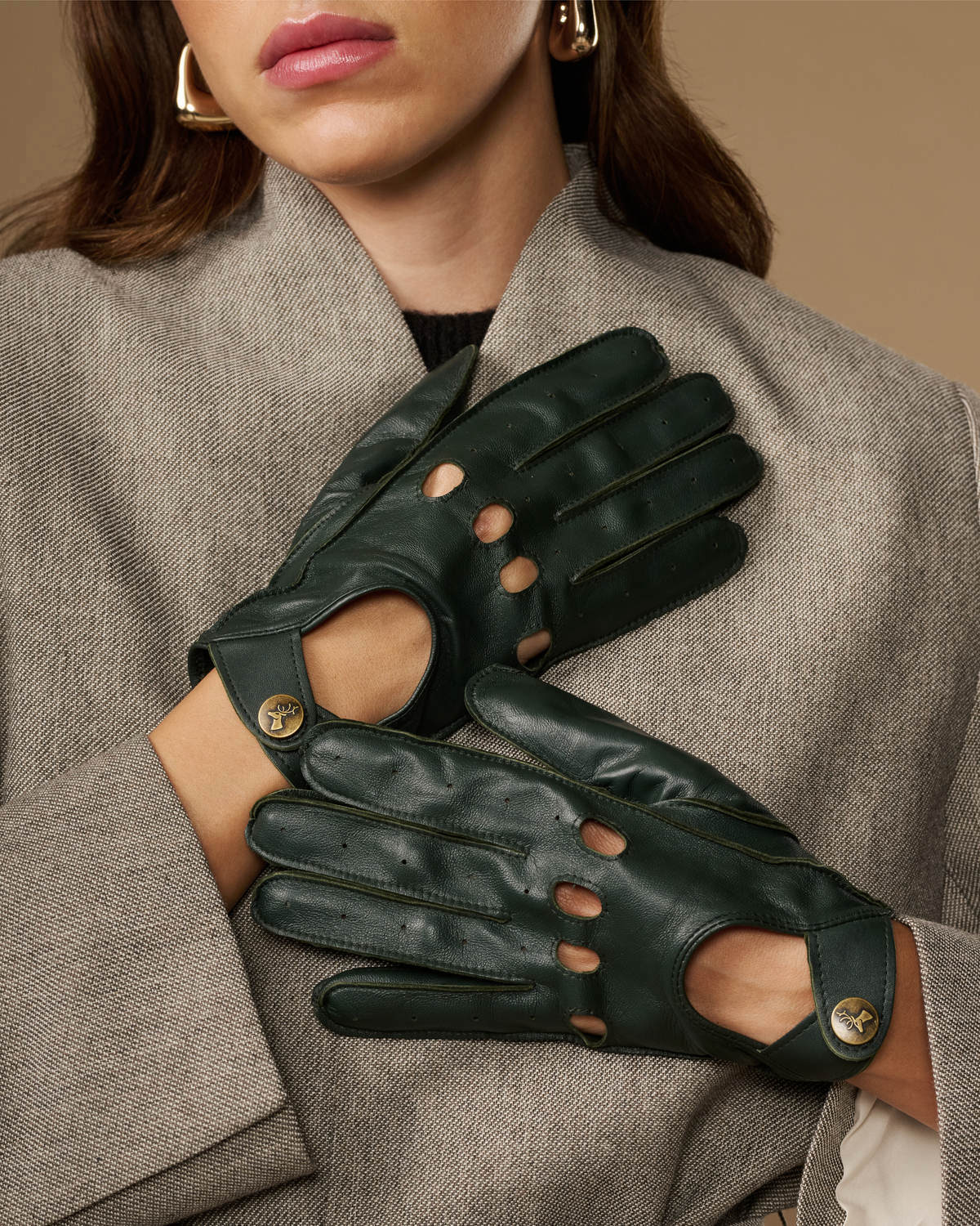 Dark green leather gloves with cutout fingertips and gold-button accents