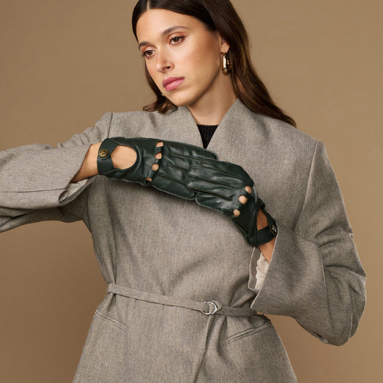 Dark green leather driving gloves with studded cutout design and round gold marks