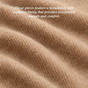 Beige cashmere lining fabric close-up inside dark leather glove