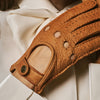 Cognac leather glove palm with oval patch, perforations, and snap wrist strap