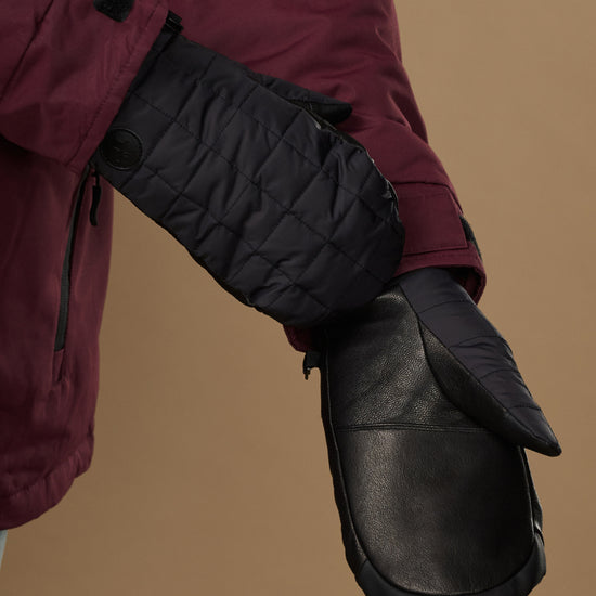Black mitten with a leather palm panel and quilted back.