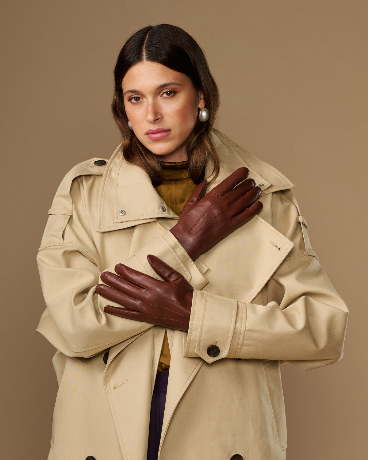 Woman wearing extra-long brown leather gloves with rabbit-fur lined cuffs