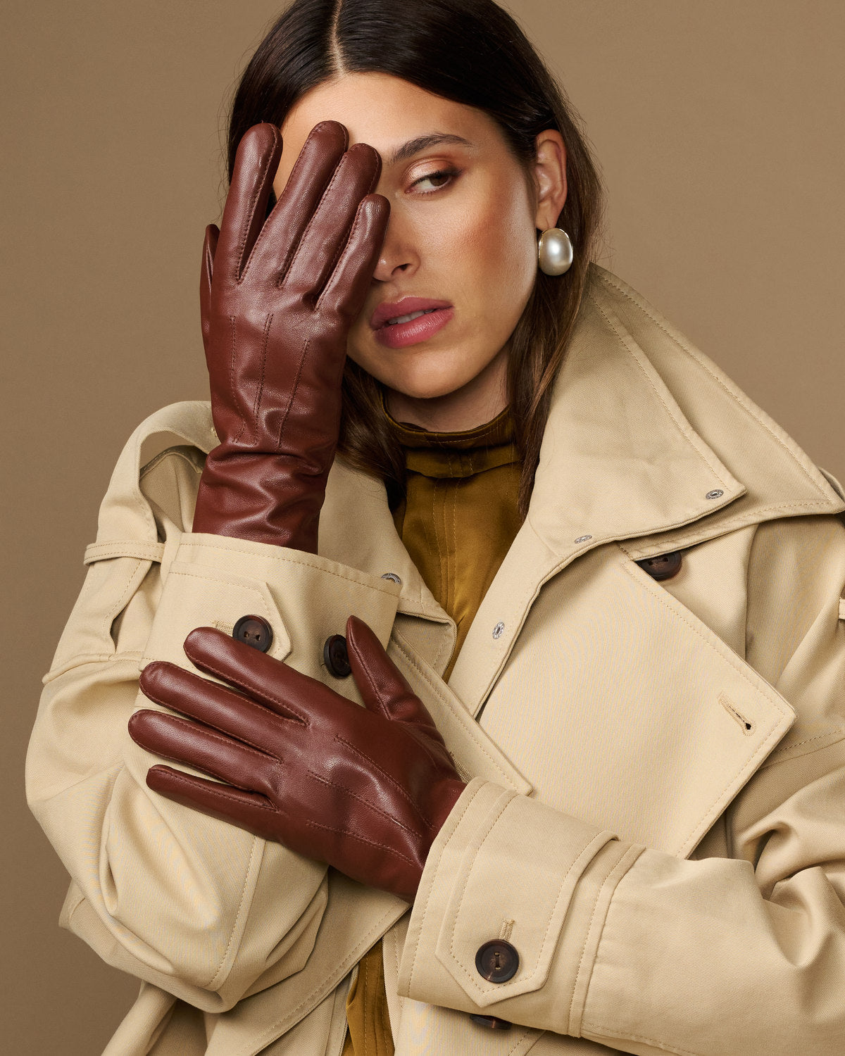 Extra-long brown leather gloves with rabbit-fur lined cuffs worn by model