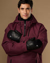 Black leather men's mittens worn crossed over the chest.