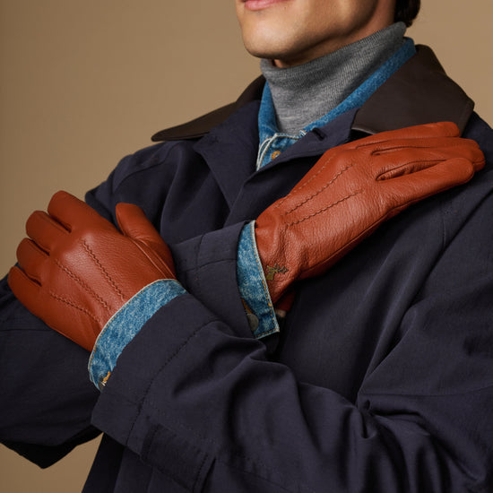 Cognac goatskin touchscreen gloves with wool lining, worn with dark coat
