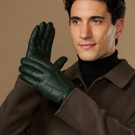 Men's dark green leather gloves, raised hand pose with stitched back