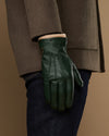 Men's dark green leather glove with wool lining at the wrist cuff