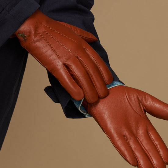 Men's cognac leather gloves, hand and cuff view with blue lambswool lining