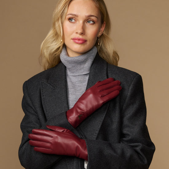 Bordeaux leather gloves for women with wool-cashmere lining, one hand folded
