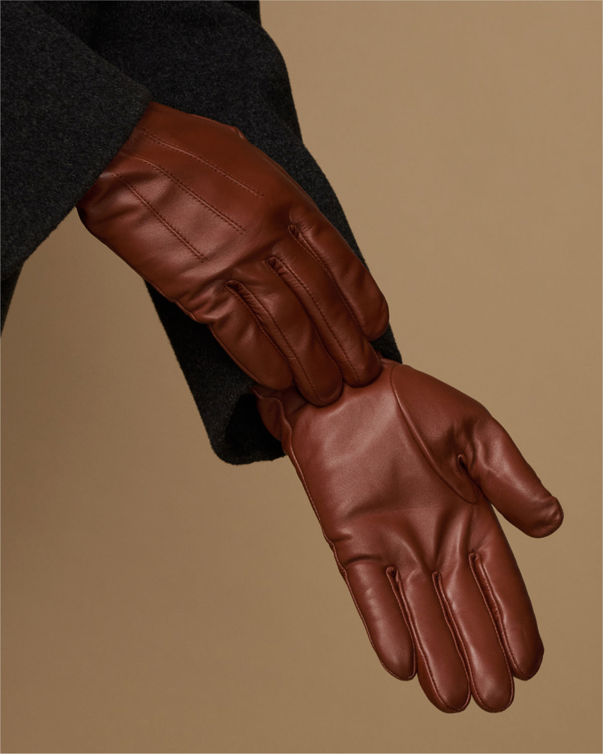 Cognac leather glove palm and fingers with stitched seams and fleece-lined cuff