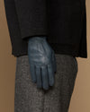 Blue sheepskin gloves with stitched seams and textured cuff