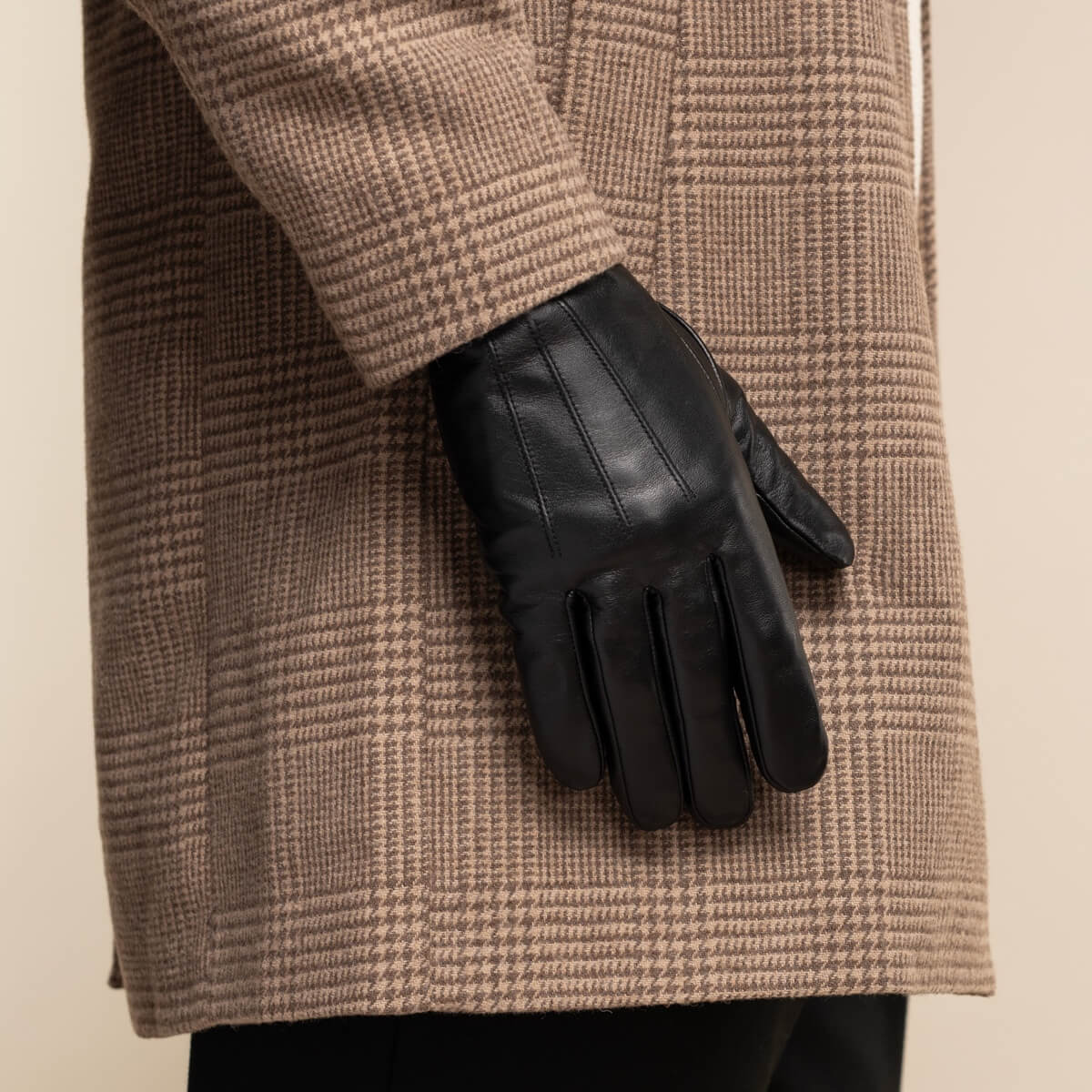 Black leather glove showing palm and finger seams