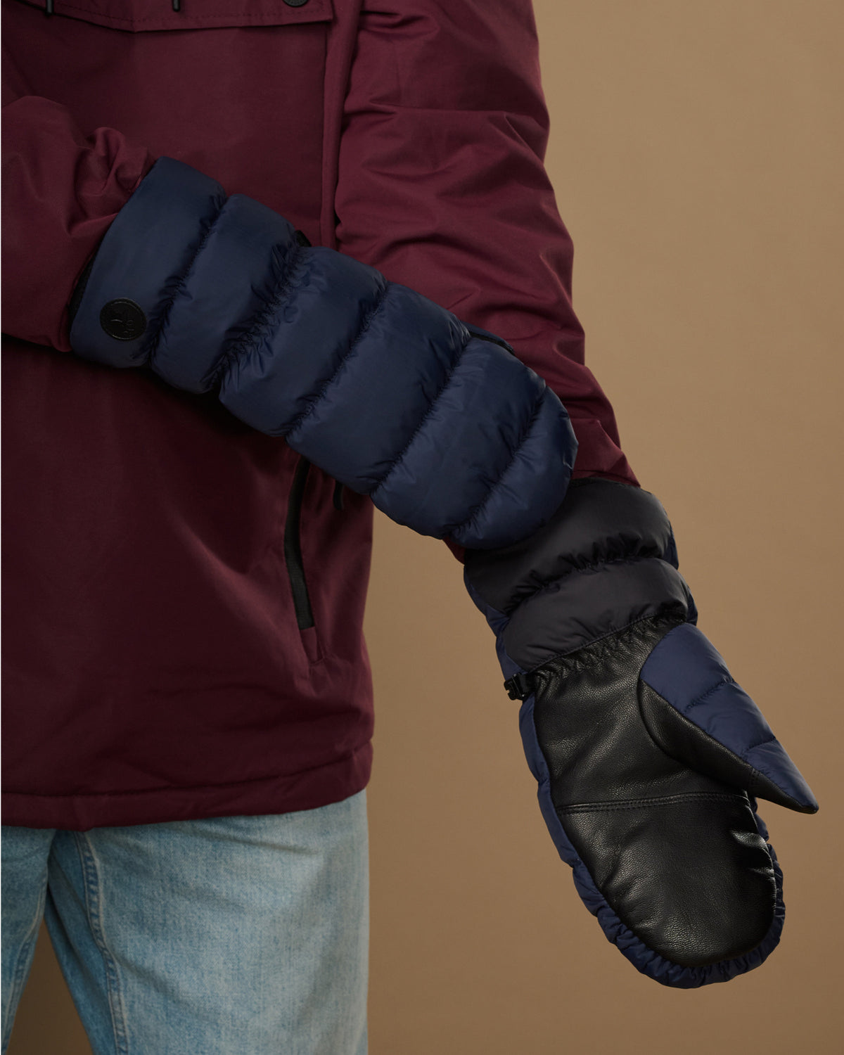 Pair of blue insulated mittens with textured cuff and dark touchscreen thumb panel