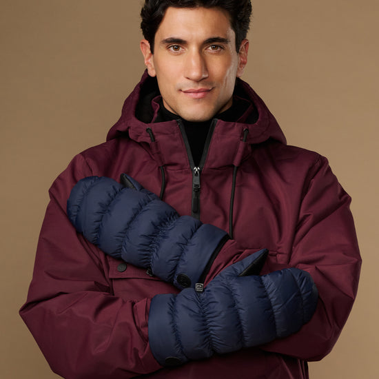Blue insulated mittens worn with maroon winter jacket sleeves