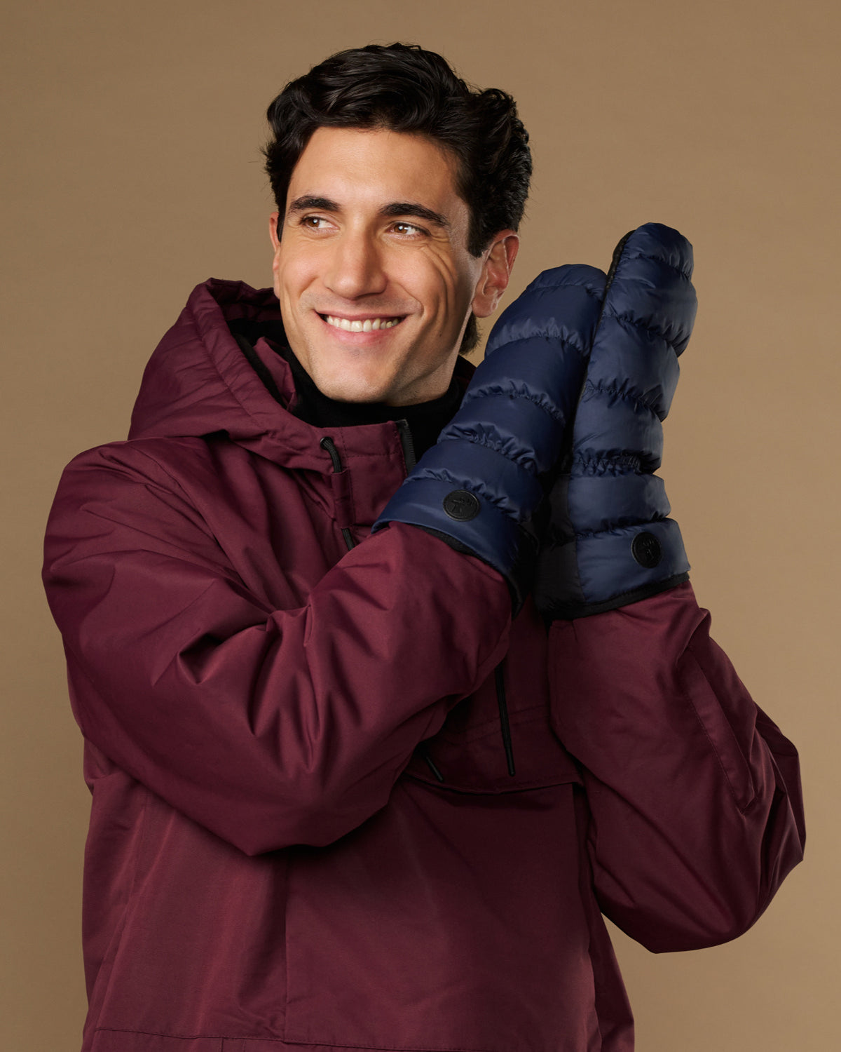 Blue down mittens with wide cuffs and button detail on the wrist
