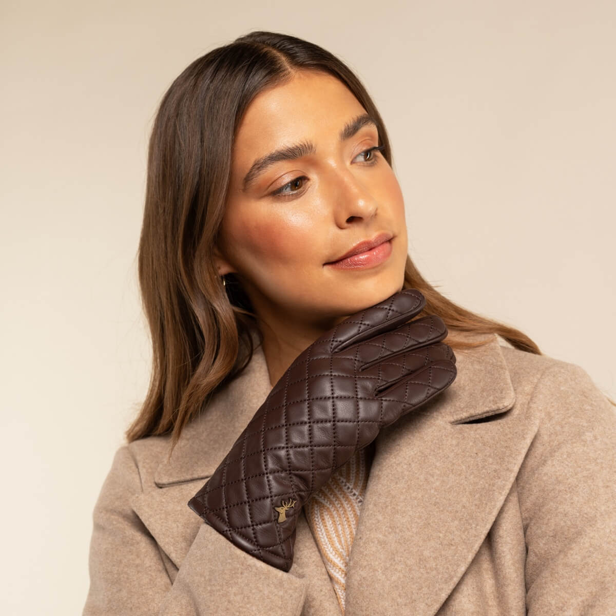 Brown quilted leather gloves with diamond stitching and cuff detail