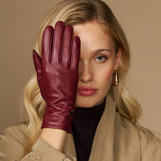 Bordeaux leather gloves with seam detailing and warm fleece lining at the cuff