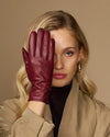 Bordeaux leather gloves with seam detailing and warm fleece lining at the cuff