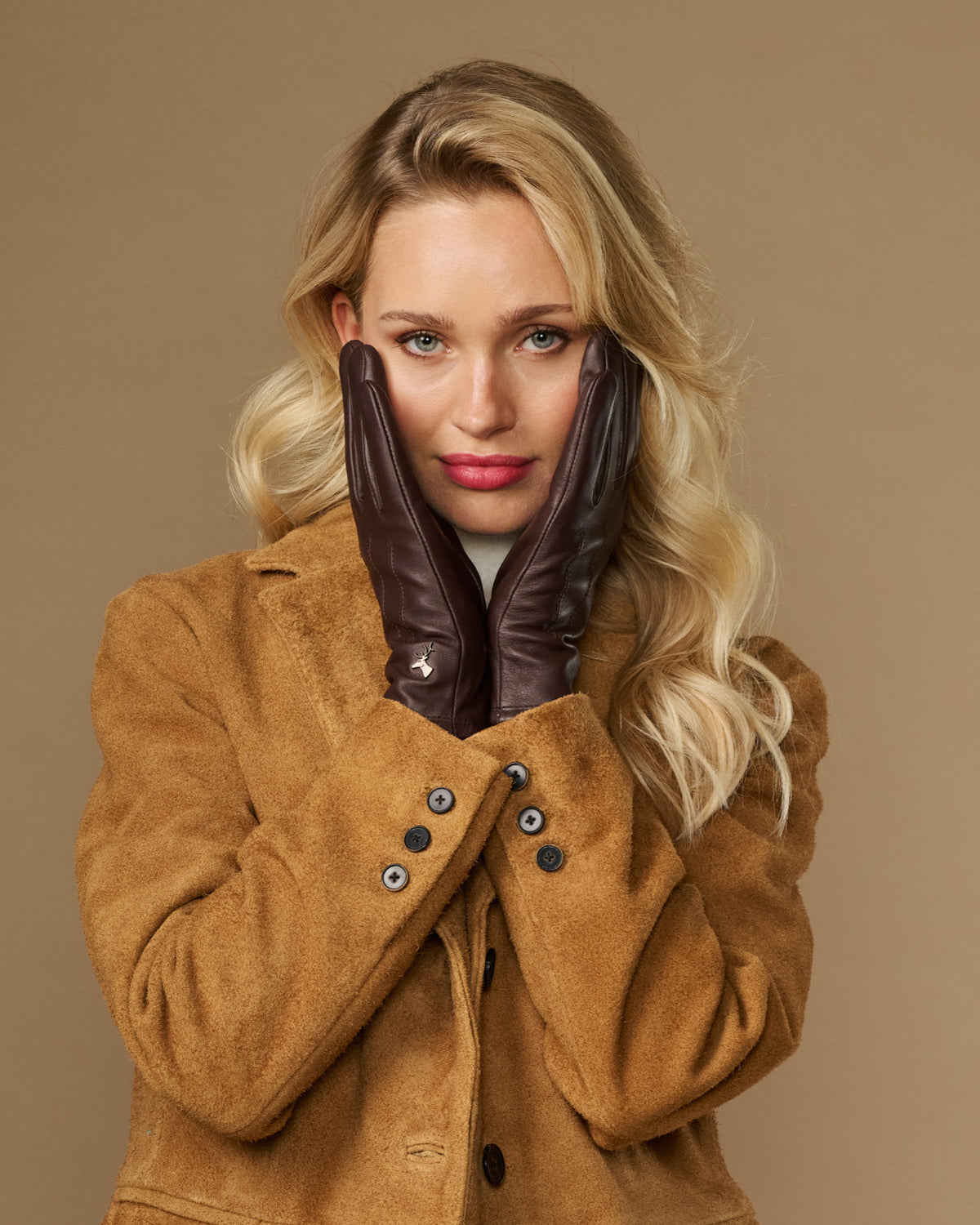 Brown fleece-lined leather gloves, knuckle detail visible while worn