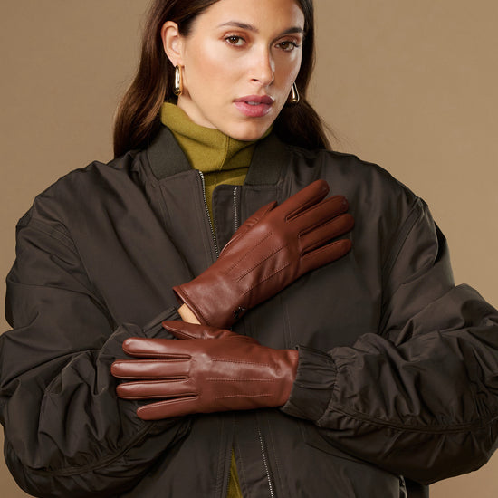 Cognac brown leather gloves with warm fleece lining, snug fit, long cuffs