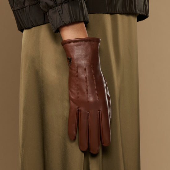 Single cognac brown leather glove with warm fleece lining and long cuff