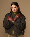 Pair of cognac brown leather gloves with warm fleece lining, snug fit, long cuffs