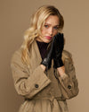 Black lambskin leather gloves with side zipper, worn close to the face