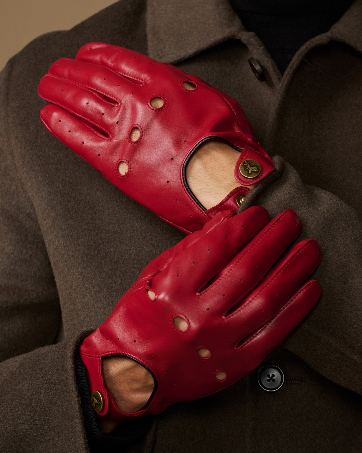 Men's red leather driving gloves, palm and thumb detail with studded stitching