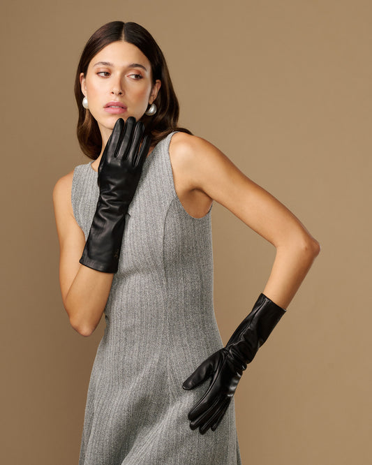 Women’s black leather mid-forearm gloves in a close hand-to-arm pose