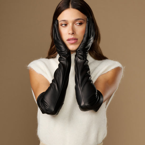 Black leather opera gloves with long fingers and silk lining at the cuffs