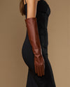 Chocolate brown leather elbow gloves shown on arm with wrist-to-elbow length
