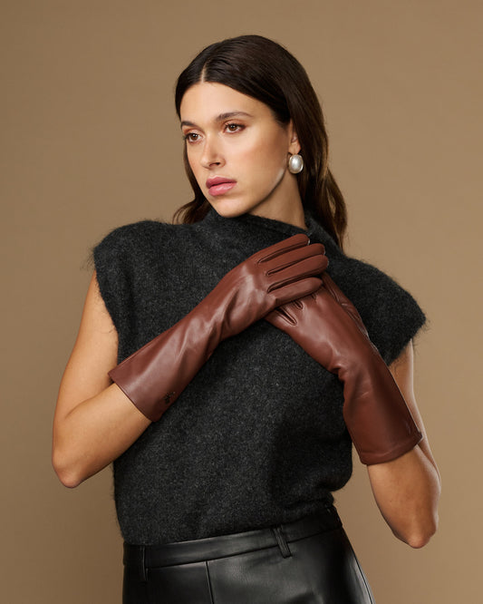Brown mid-forearm lambskin leather gloves, snug fit, worn on model's hands
