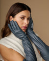 Women's grey leather gloves with silk lining and touchscreen fingertips, close-up view