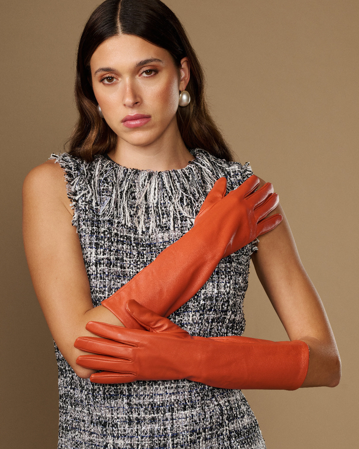 Women’s orange below-elbow leather gloves with smooth lambskin finish and wrist cuff