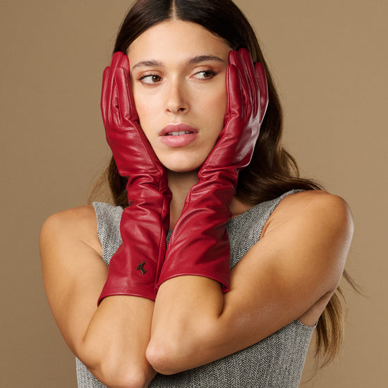 Women’s red below-elbow leather gloves with smooth finish and folded cuff detail
