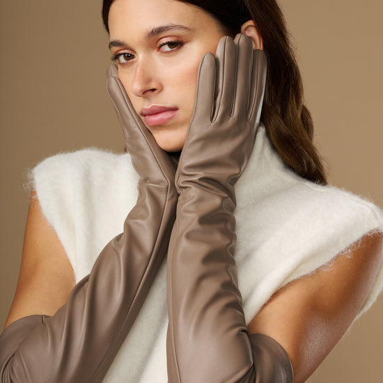 Front view of taupe leather gloves with long cuffs and fitted finger panels