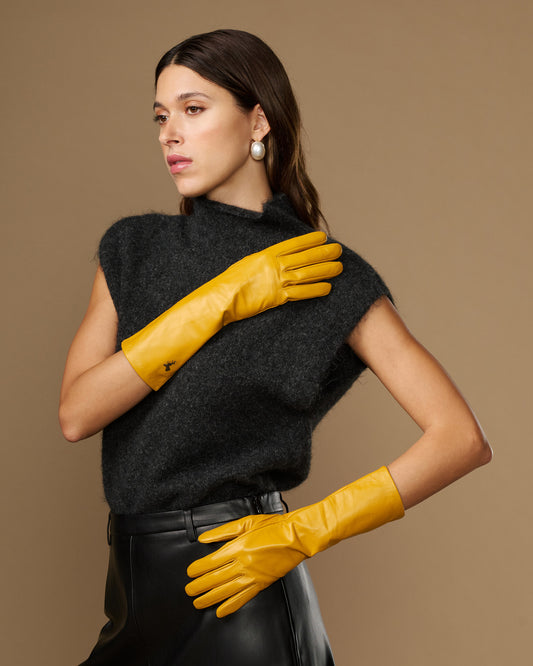 Yellow mid-forearm leather gloves with smooth finish and stitched finger panels