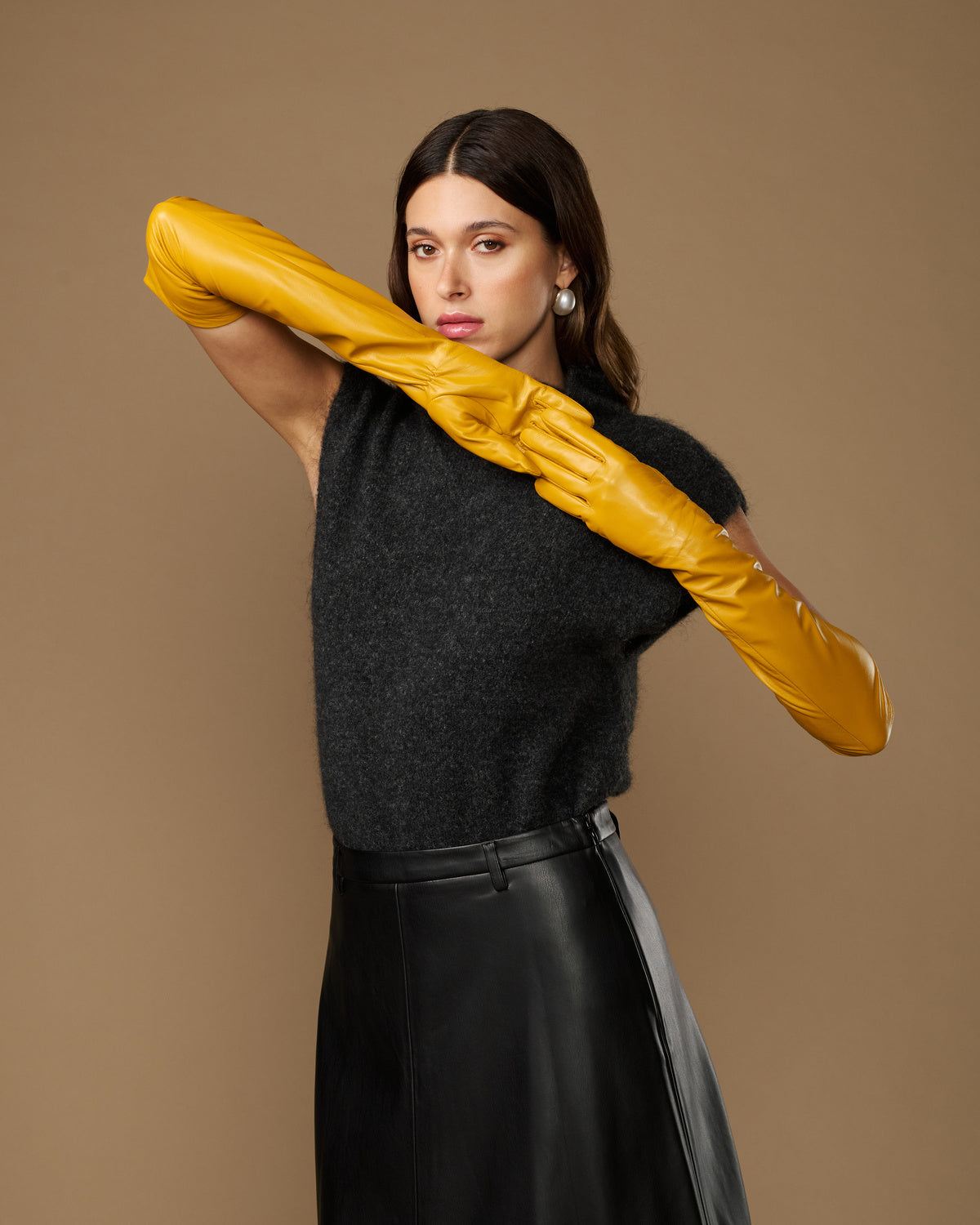 Yellow lambskin leather opera gloves, long fitted style held overhead