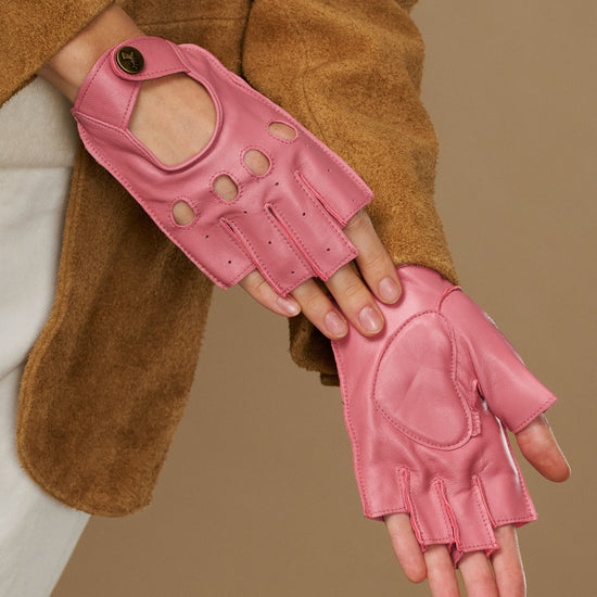Pink fingerless lambskin driving gloves with open finger tips and stitched panels