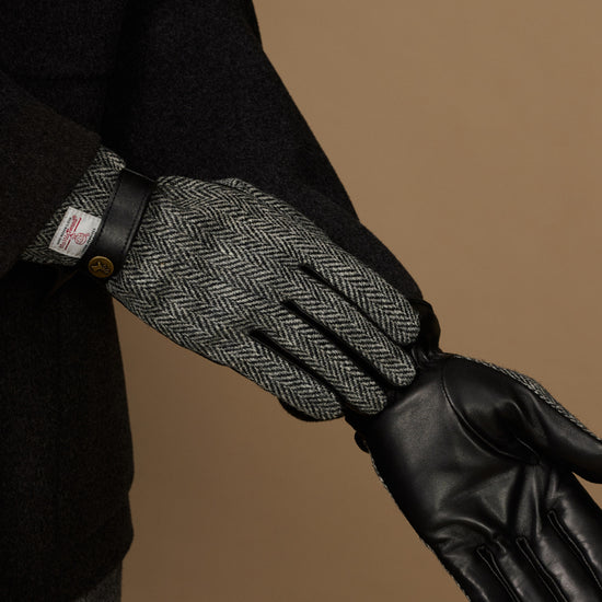 Men's gloves with gray herringbone interior and black leather hand section and cuff.