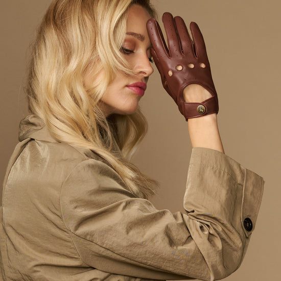 Brown leather driving gloves with perforated fingers and buttoned cuff detail
