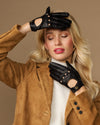 Black leather driving gloves with snap buttons and open-finger touchscreen panels.