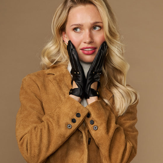 Black leather driving gloves with stud accents and elastic wrist cuffs.